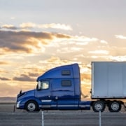 relocation vendor truck driving long road at sunset