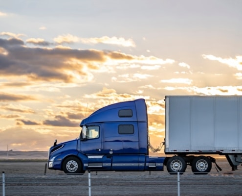 relocation vendor truck driving long road at sunset