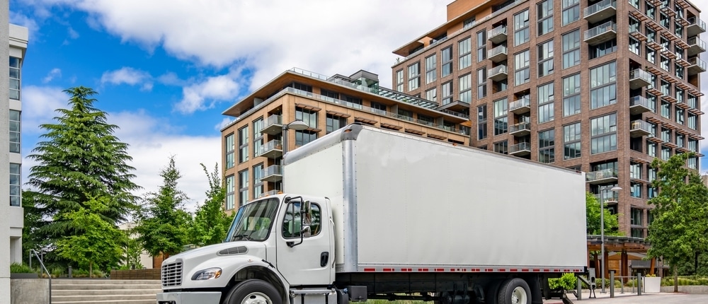 commercial relocation project management company using a plain white moving truck to relocate a business